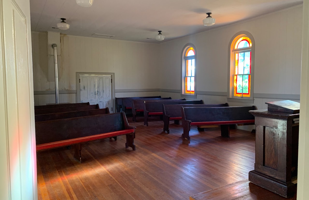 Chapel interior with pews and stained glass windows